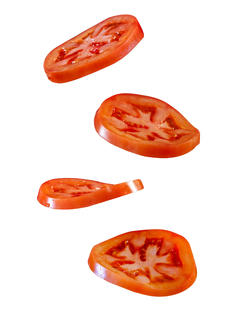 Slices of tomato falling down on a transparent background