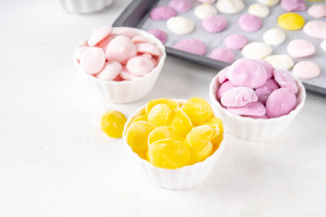 Bowls of yellow and pink yoghurt drops.